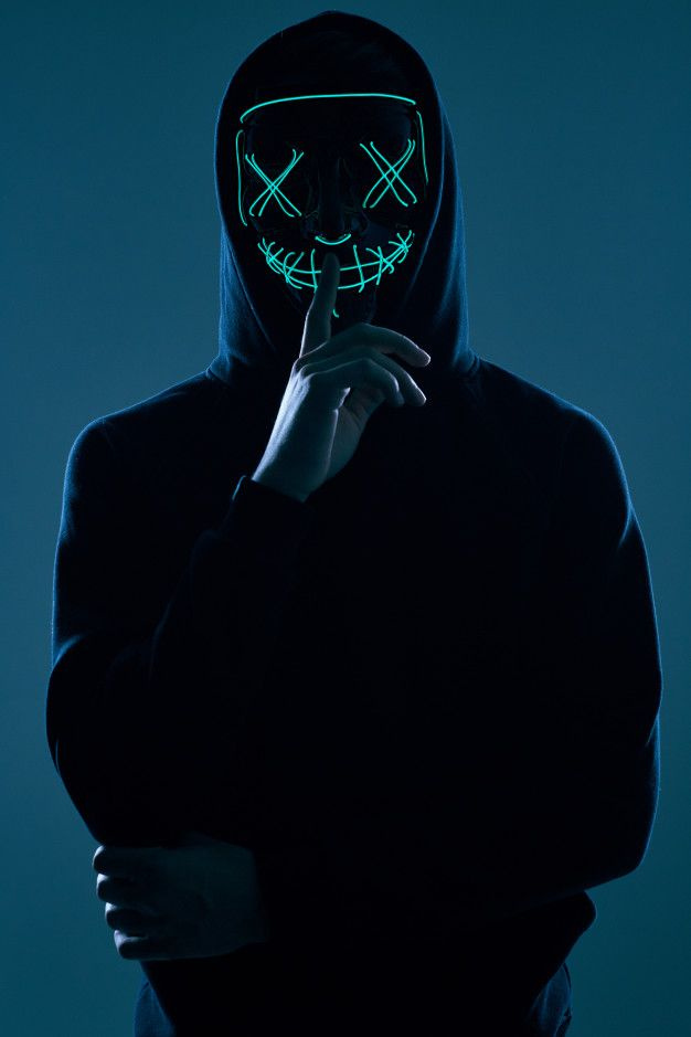 Premium Photo _ Anonymous man in black hoodie hiding his face behind a neon mask