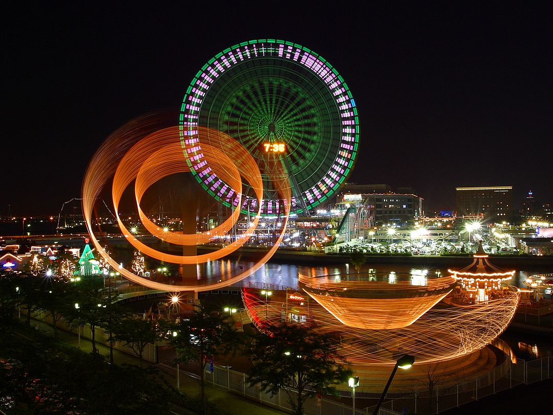 Cosmo Clock 21 Ferris Wheel in Yokohama The giant Ferris Wheel in Yokohama, located in the Cosmo World amusement Park in the Minato Mirai area. It was opened in 1989 and was the tallest Ferris wheel in the world until 1999. The wheel owes its name to the famous clock located on the supports. The number 21 means "21st century".