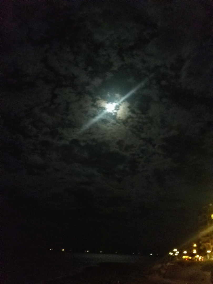 Cloudy Moon over the Vivid City Lights