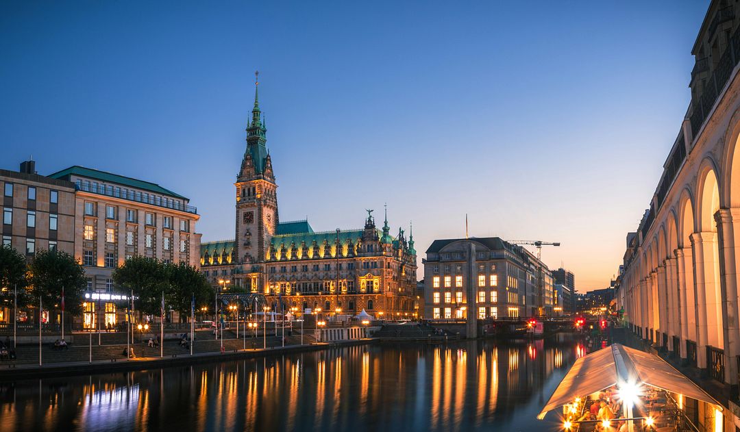 The image shows the Hamburg Town Hall in Hamburg, Germany.  Hamburg City Hall (Hamburger Rathaus) is the seat of the local government (Senate) and parliament of the free Hanseatic city of Hamburg.   Location: in the center of Hamburg, in the Altstadt quarter, on Rathausmarkt Square, near Lake Binnenalster and the central station.   History: The old Hamburg Town Hall was destroyed by the Great Hamburg Fire of 1842, and the construction of the new one took almost 44 years. The building was designed by a group of seven architects led by Martin Haller.   Architecture: The exterior of the town hall is built in the Neo-Renaissance style. It is one of the few completely preserved buildings of historicism in Hamburg.