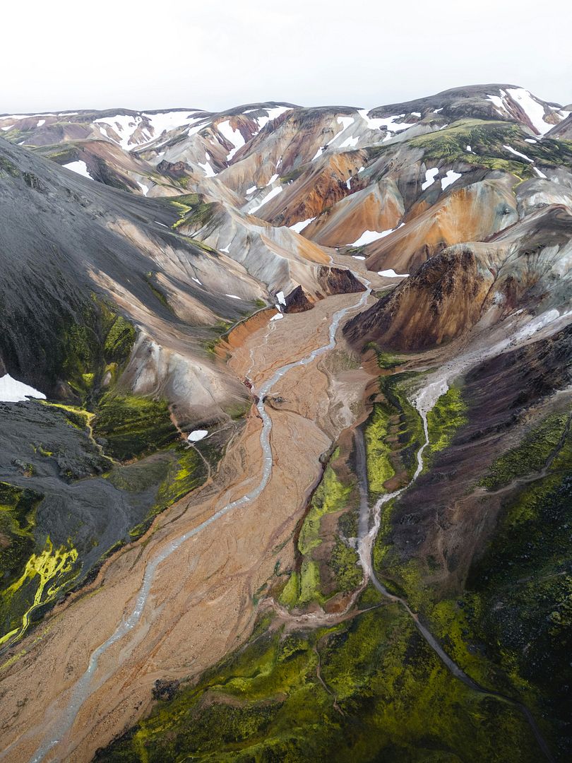 an aerial view of a mountain with a river running through it