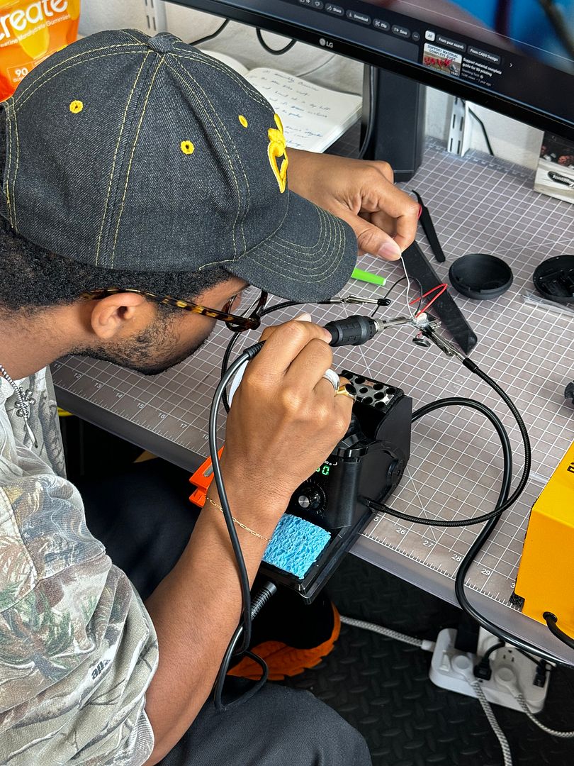 Teaching Reggie to solder earlier this summer