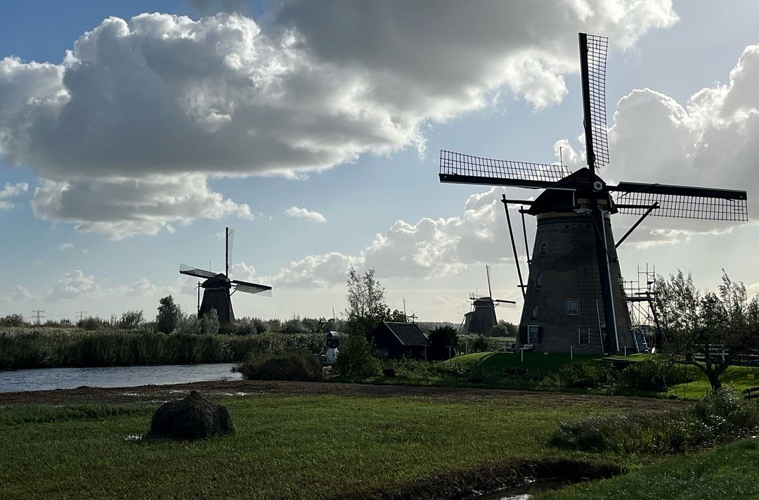 Windmills against cloudy skies, outside Amsterdam, Netherlands