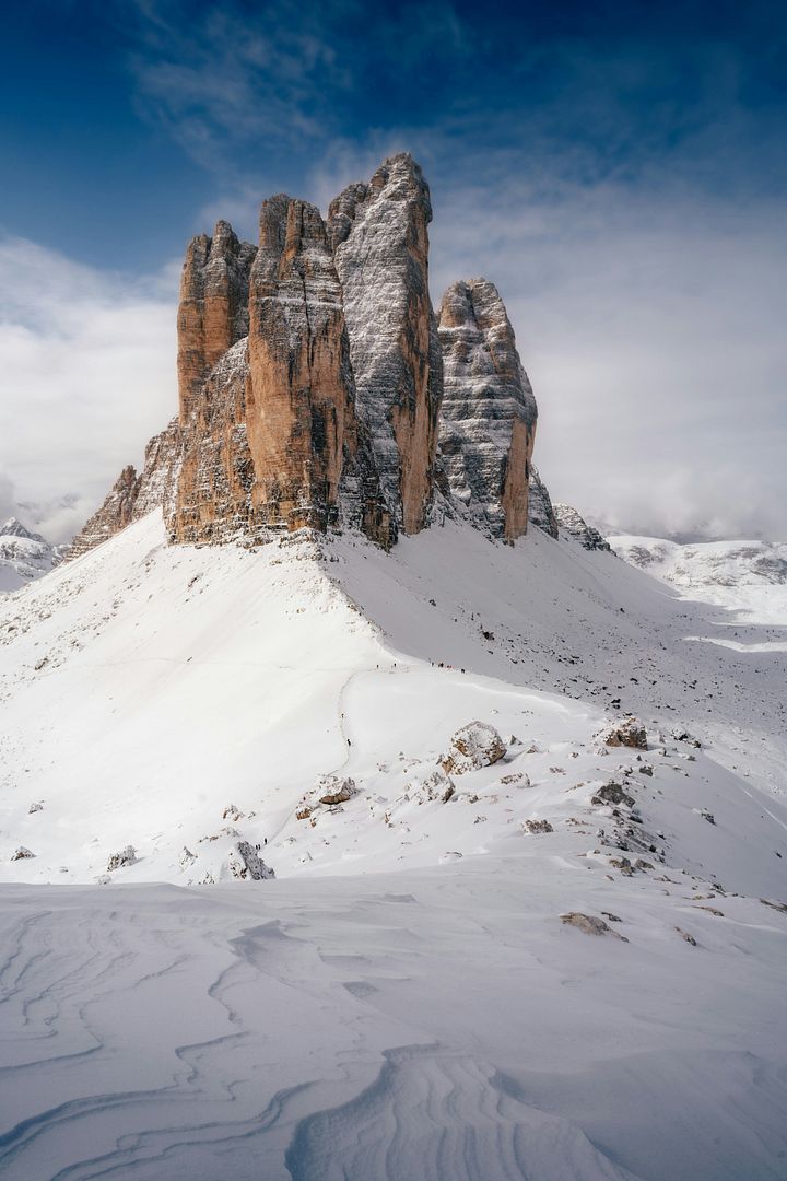 a mountain covered in snow under a blue sky