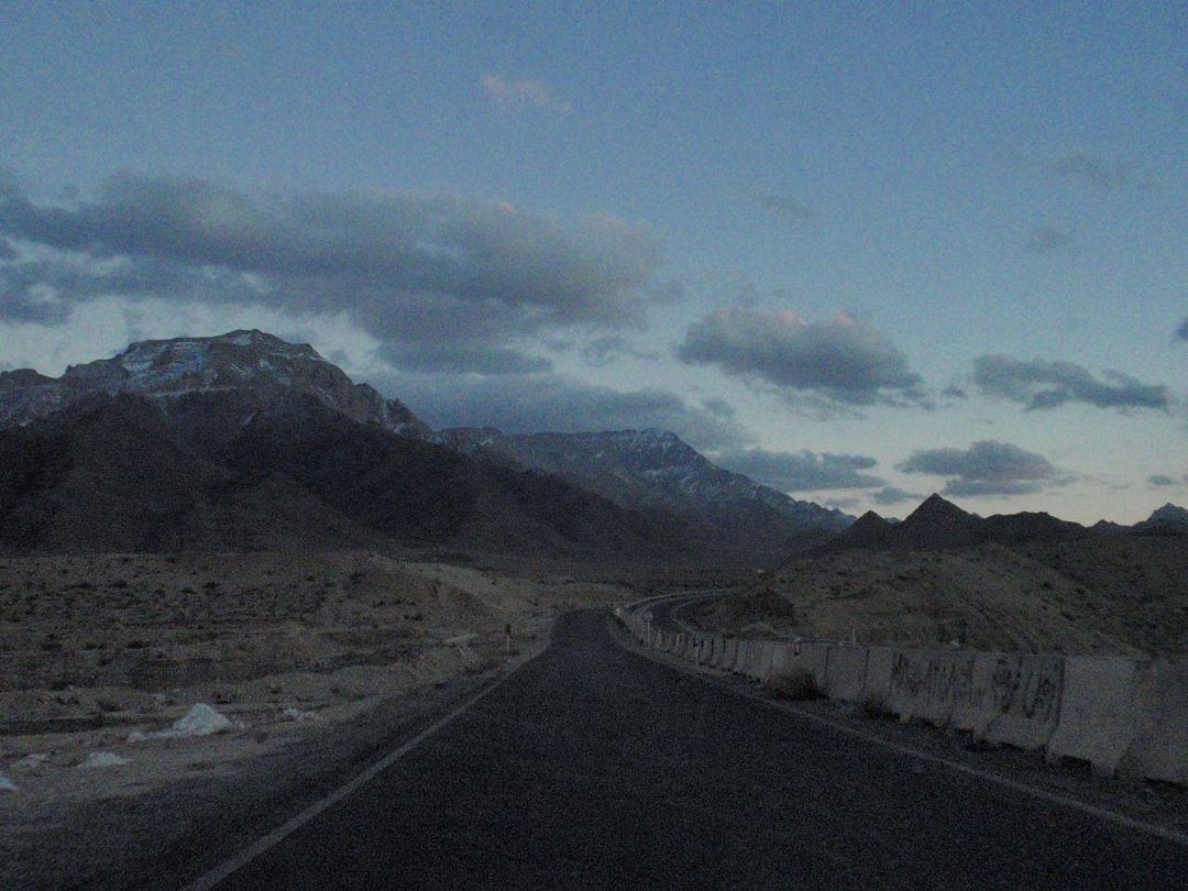 Endless road into the snowy mountains