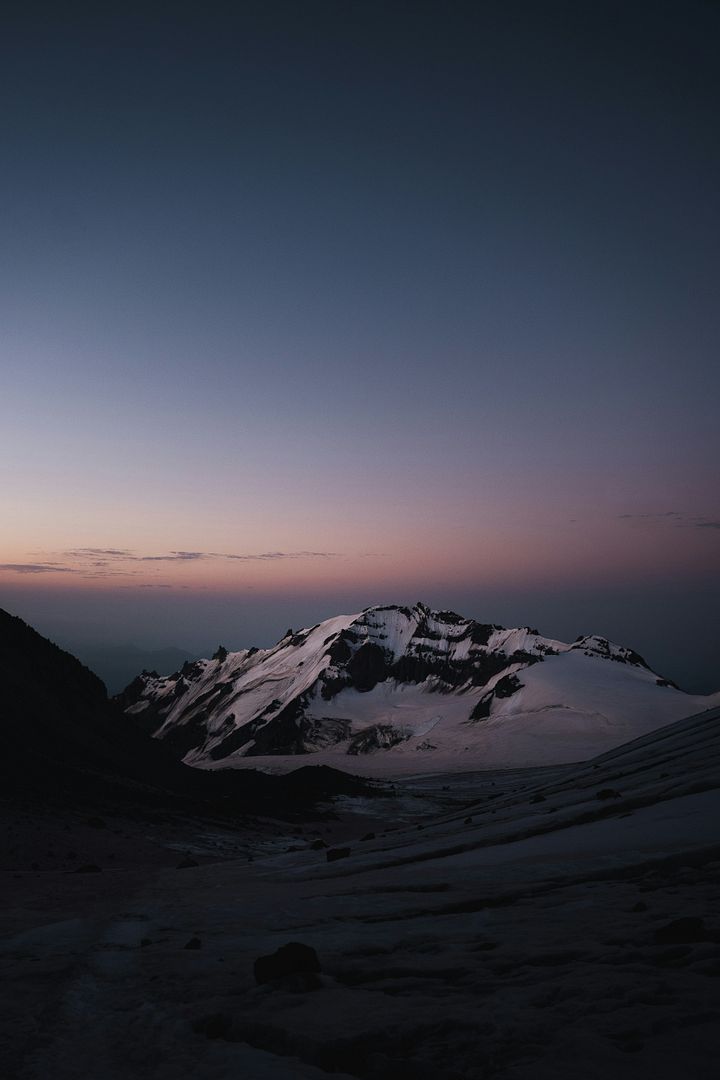 a snow covered mountain with a sky background