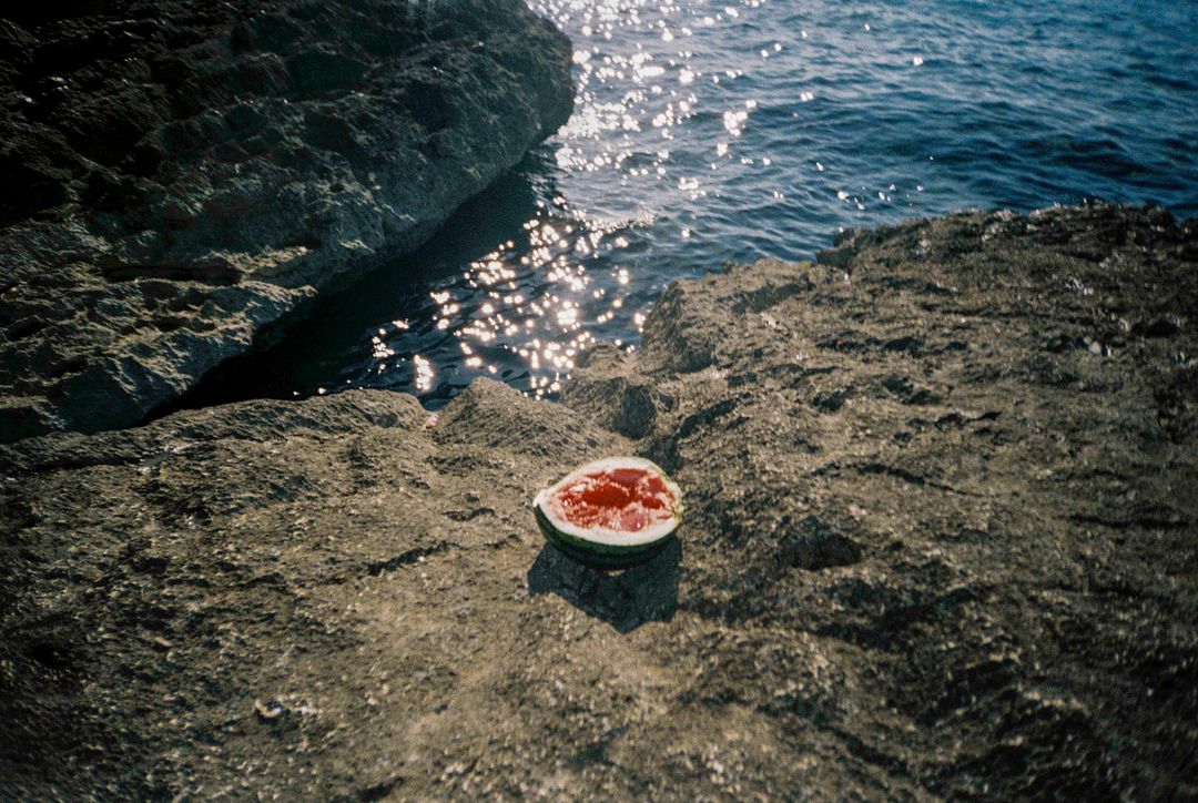 Half of a watermelon by the beach