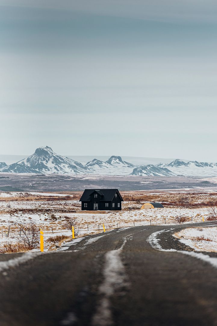 A road with a house in the middle of it