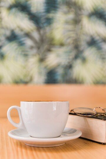 A mug near glasses and books