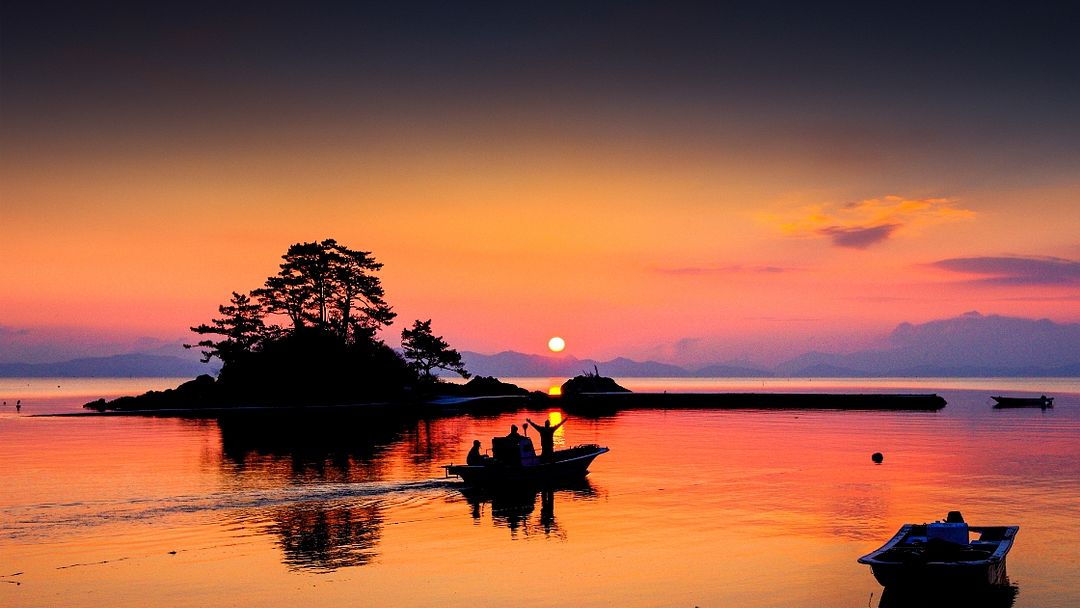 Sunset beach and people on sailboat