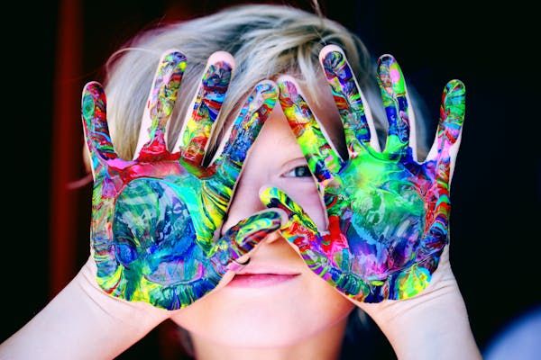 Kids with colorful hands.