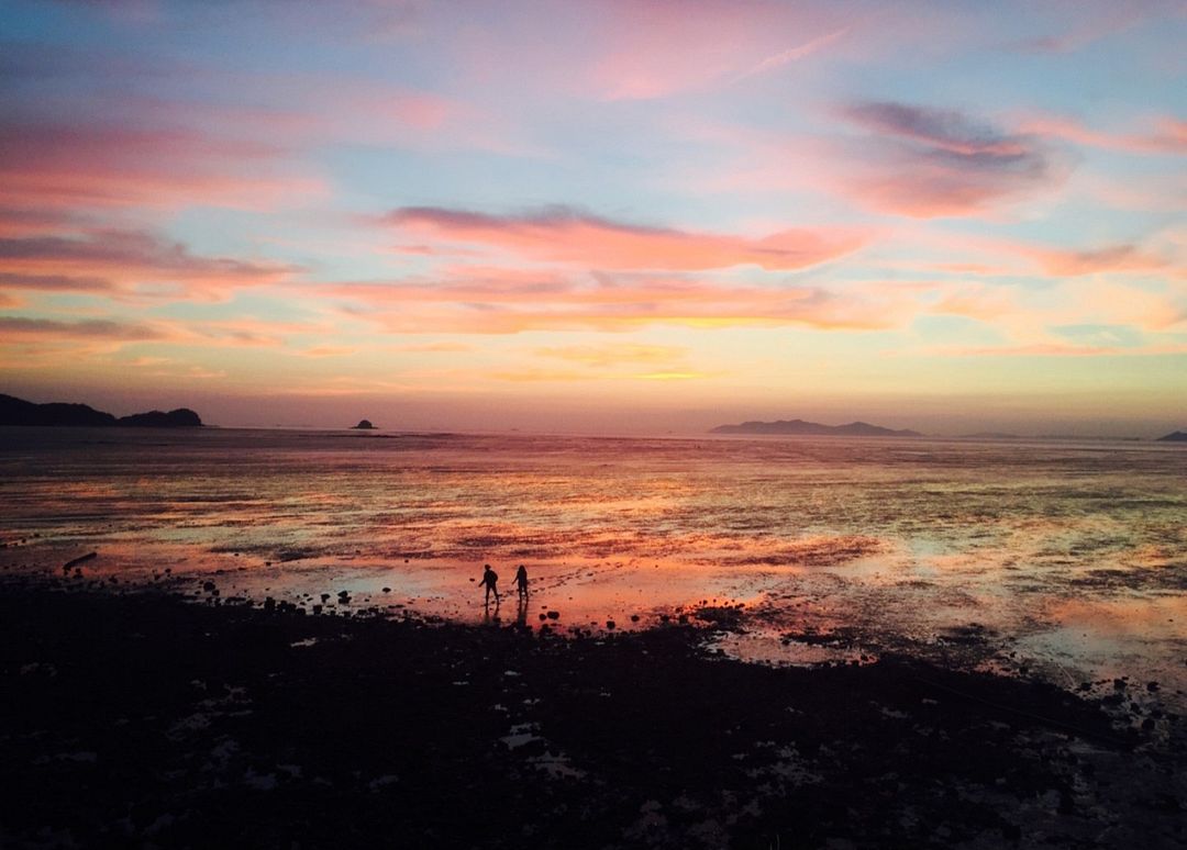 A lover walking on the tidal flats at sunset