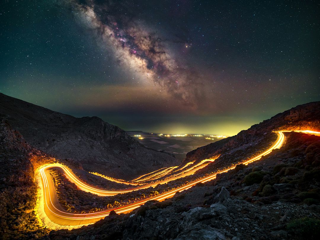 a long exposure shot of a road at night