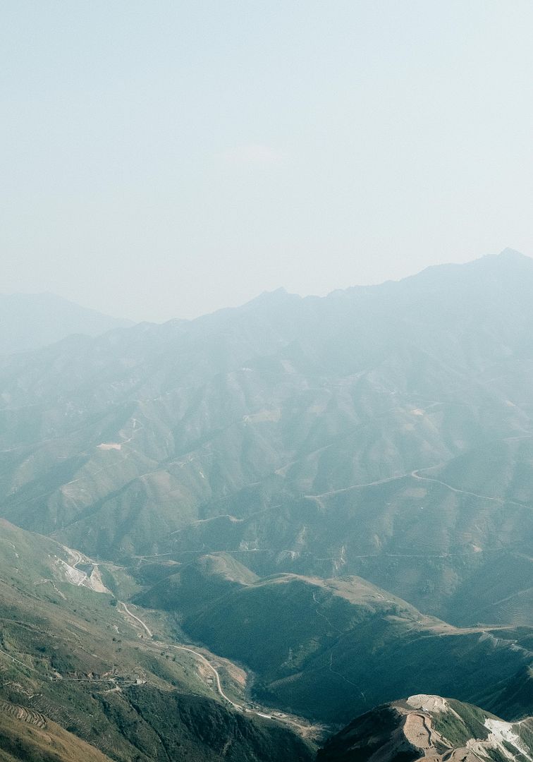 A view of mountains and valleys from a plane