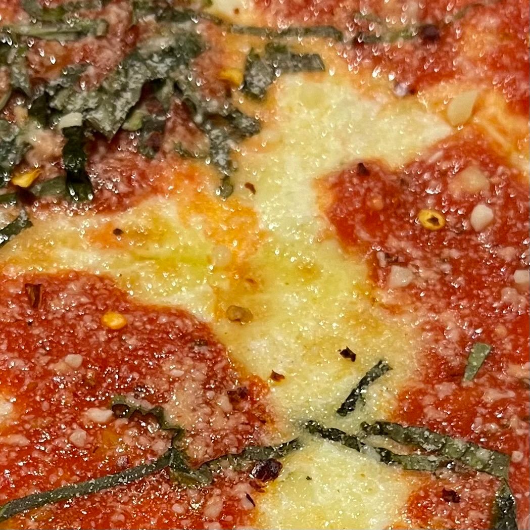 Slice of pizza after omakase in New York City