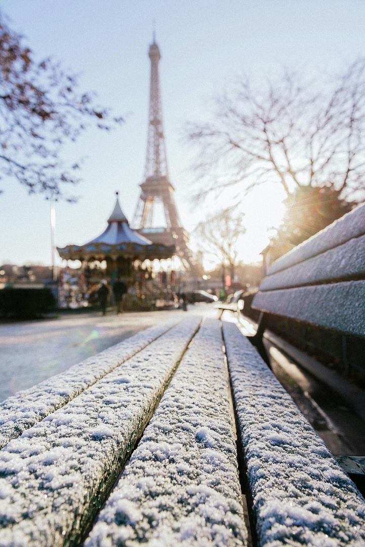 Snow on a bench in front of the Eiffel Tower