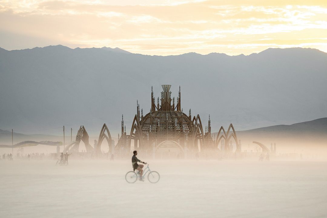 a person riding a bike on a foggy day