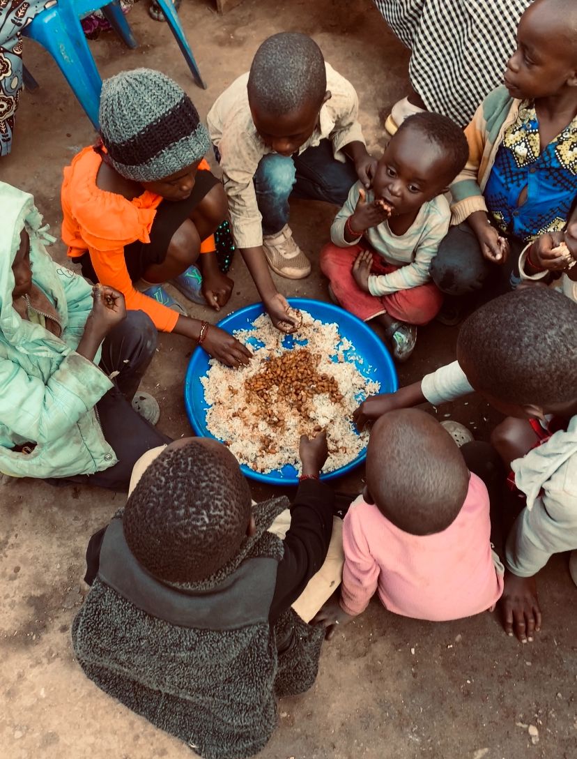 “Shared plates, shared hope. In every meal, these children find more than food—they find connection, strength, and a future filled with possibility. Their resilience is a reminder that even in the hardest times, there is always room for kindness and unity. Being a refugee is not a decision, but a situation, and their strength shines through in every moment.”  Photography by Johnson JB